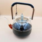 Elegant glass teapot with silver infuser and wooden handle